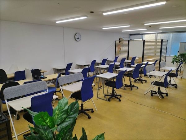 明るい教室に机と椅子が並んでいる様子